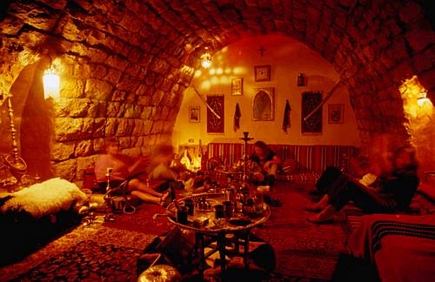 Tourists relaxing in a Nargileh den